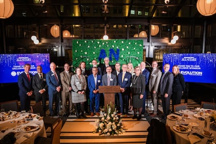 A group of awardees on stage during a gala event.