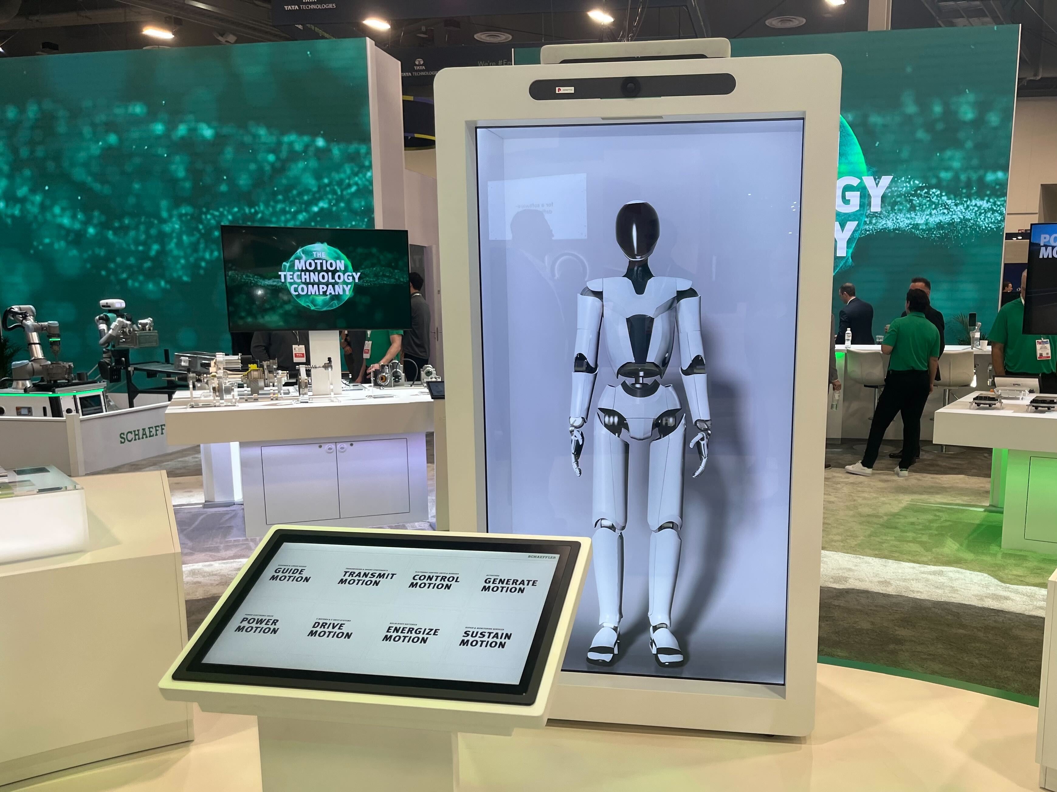 A white, human-shaped robot on display at a technology show.