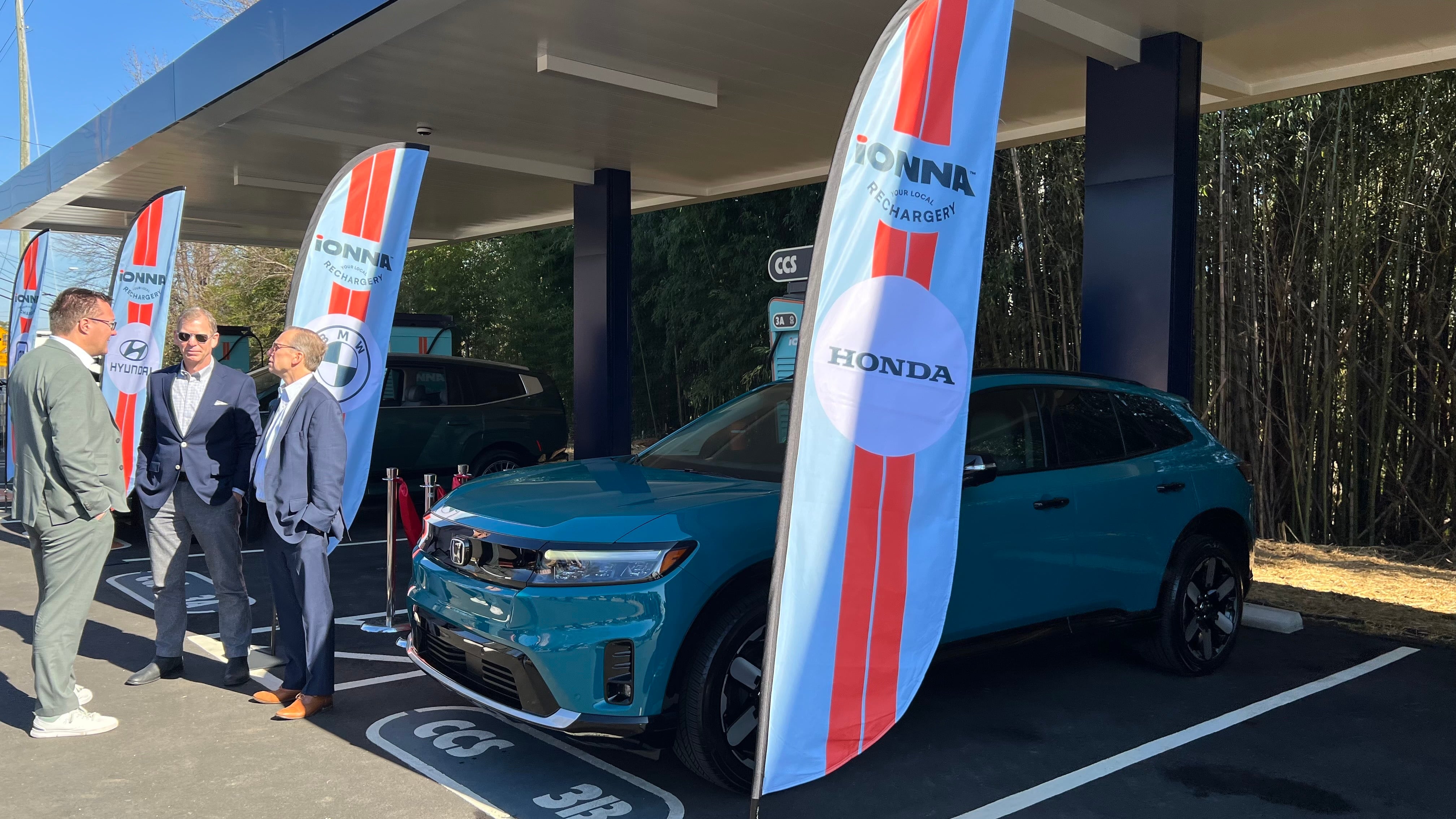 Nico Dettmer of Mercedes-Benz chats with Jay Joseph and Bob Nelson of Honda at Ionna's ribbon cutting in North Carolina.