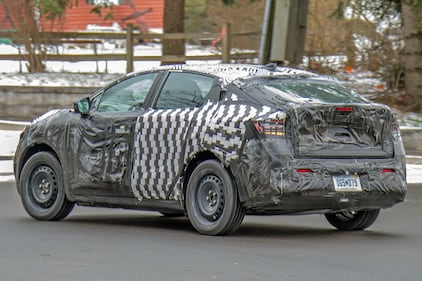 The rear of a Nissan electric vehicle with heavy camouflage spotted in Metro Detroit.