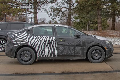 Camouflaged Nissan EV side profile