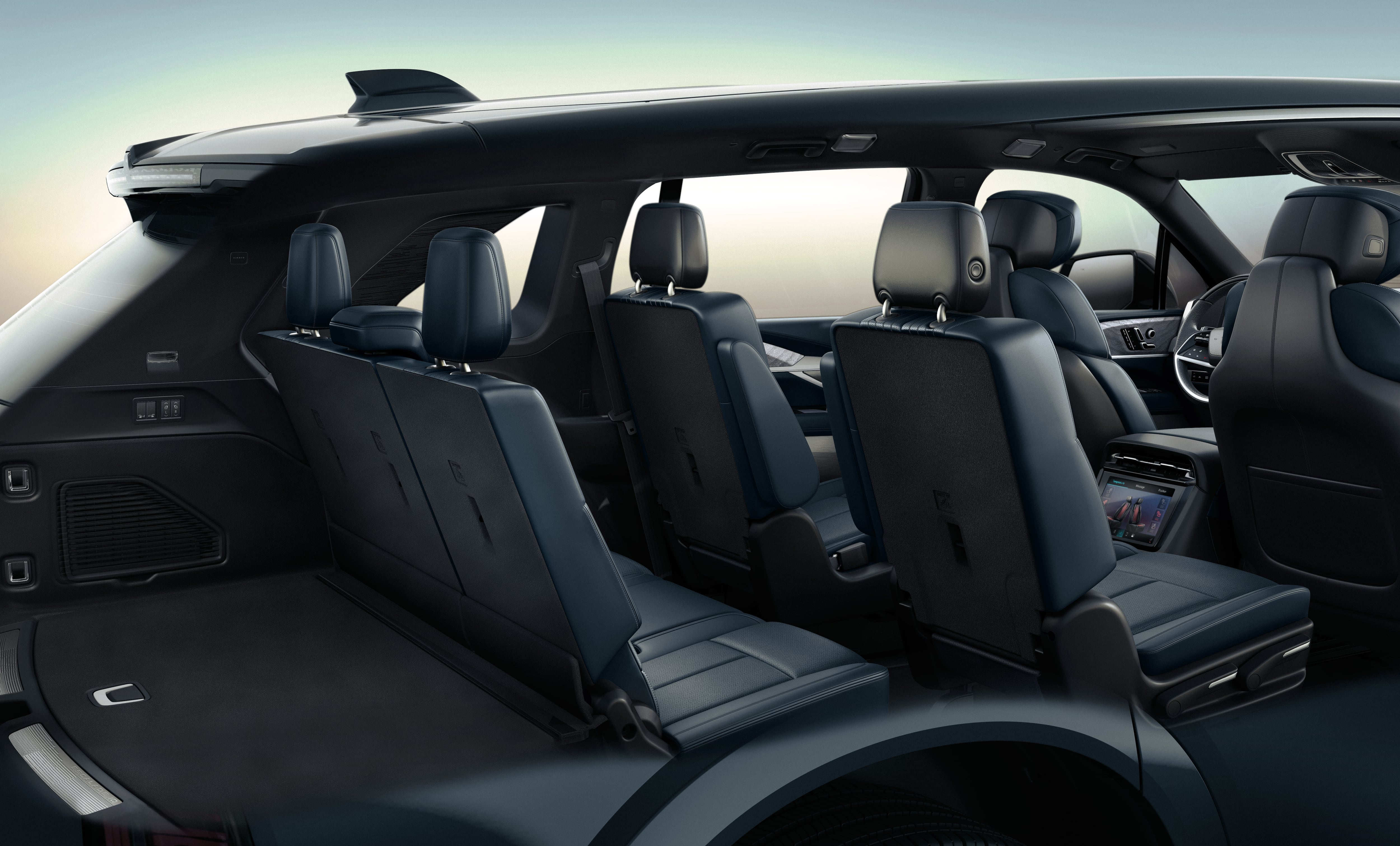 A cutaway image showing all three rows of seats and rear cargo storage in the 2026 Cadillac IQL electric full-size SUV.