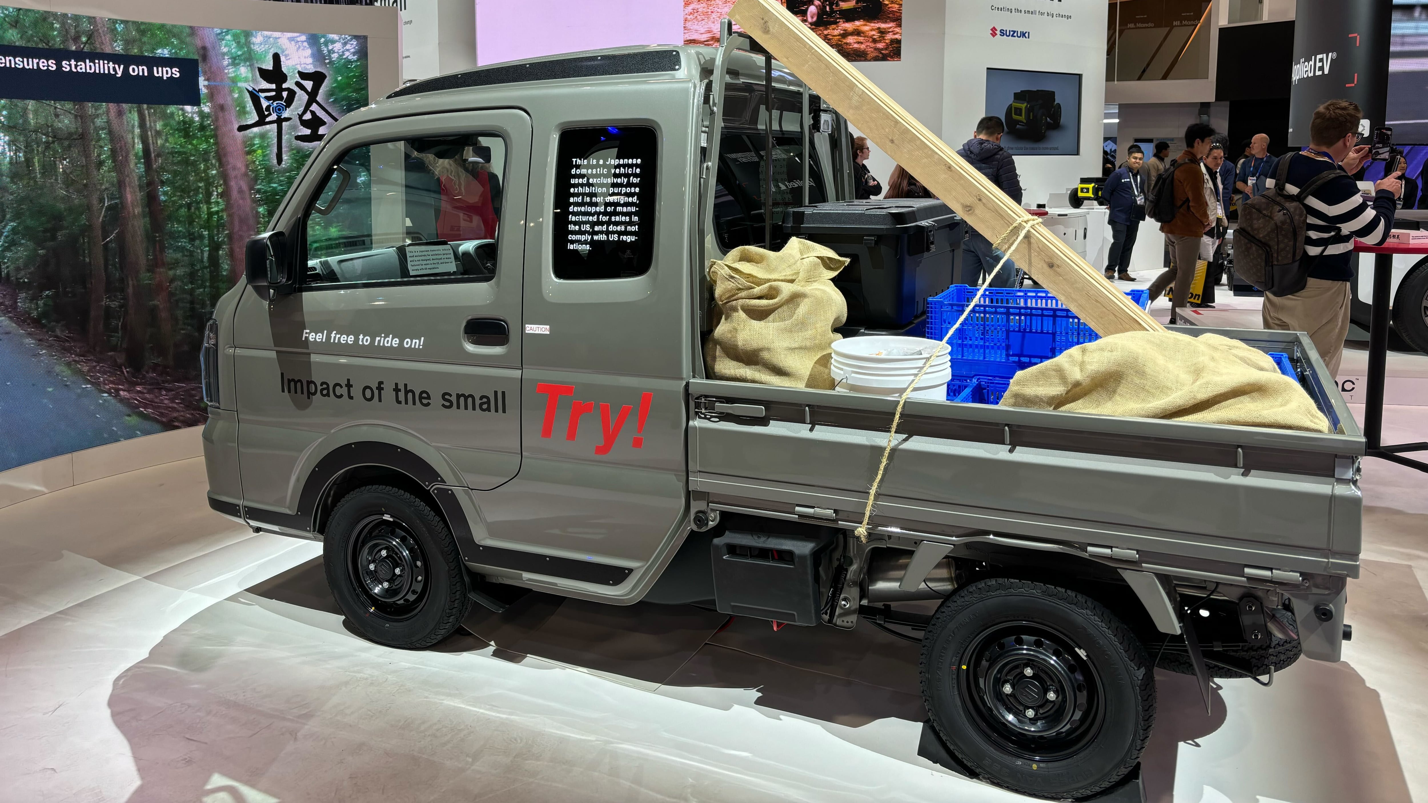 A mini truck on display at an automotive technology show.