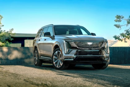 The 2026 Cadillac Escalade IQL electric full-size SUV shown in a front-facing side profile.