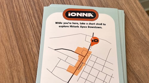 A flyer with a map to downtown Apex, N.C., at Ionna charging station.