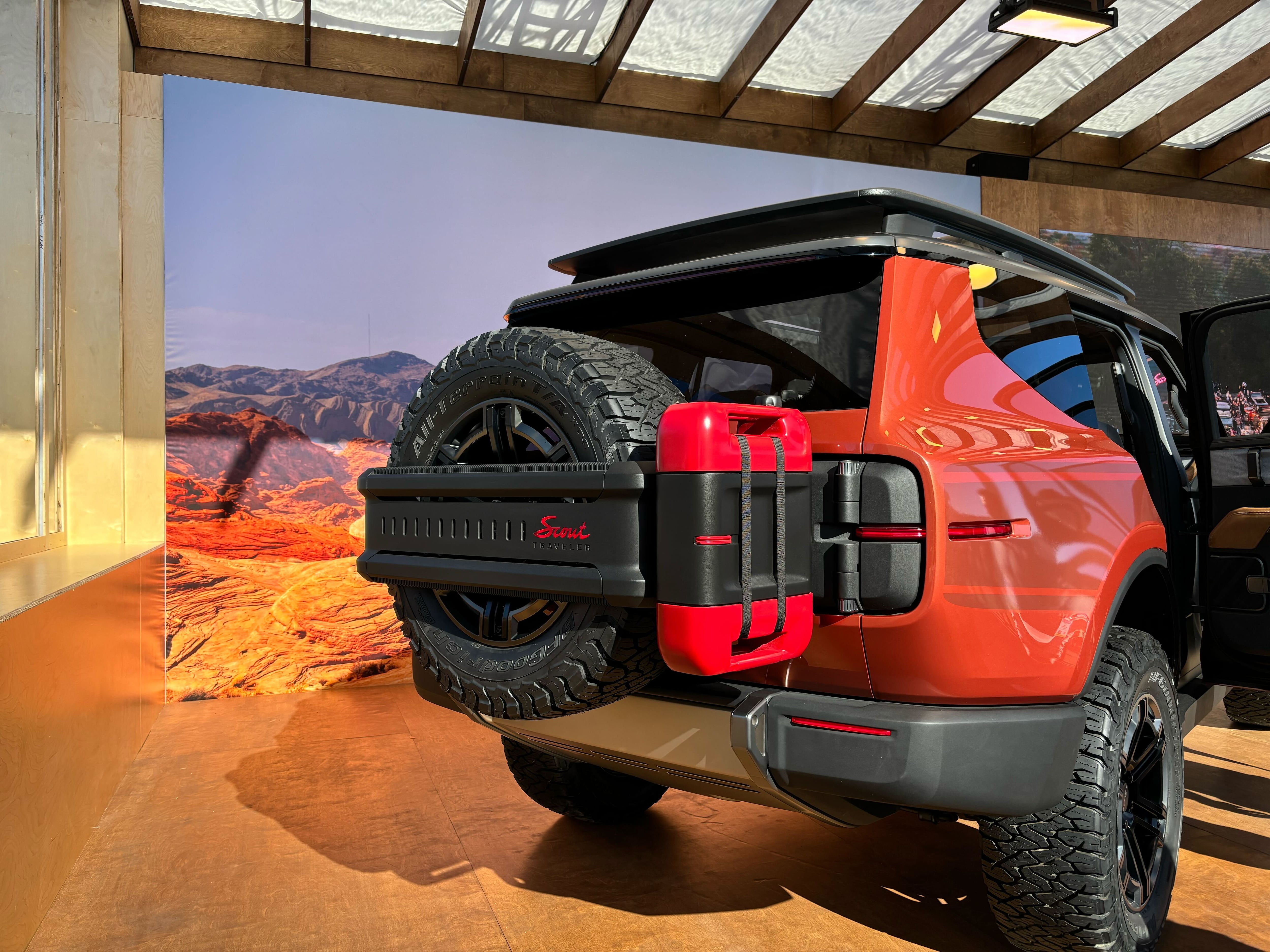 Rear view of an burnt orange electric SUV at the CES show.