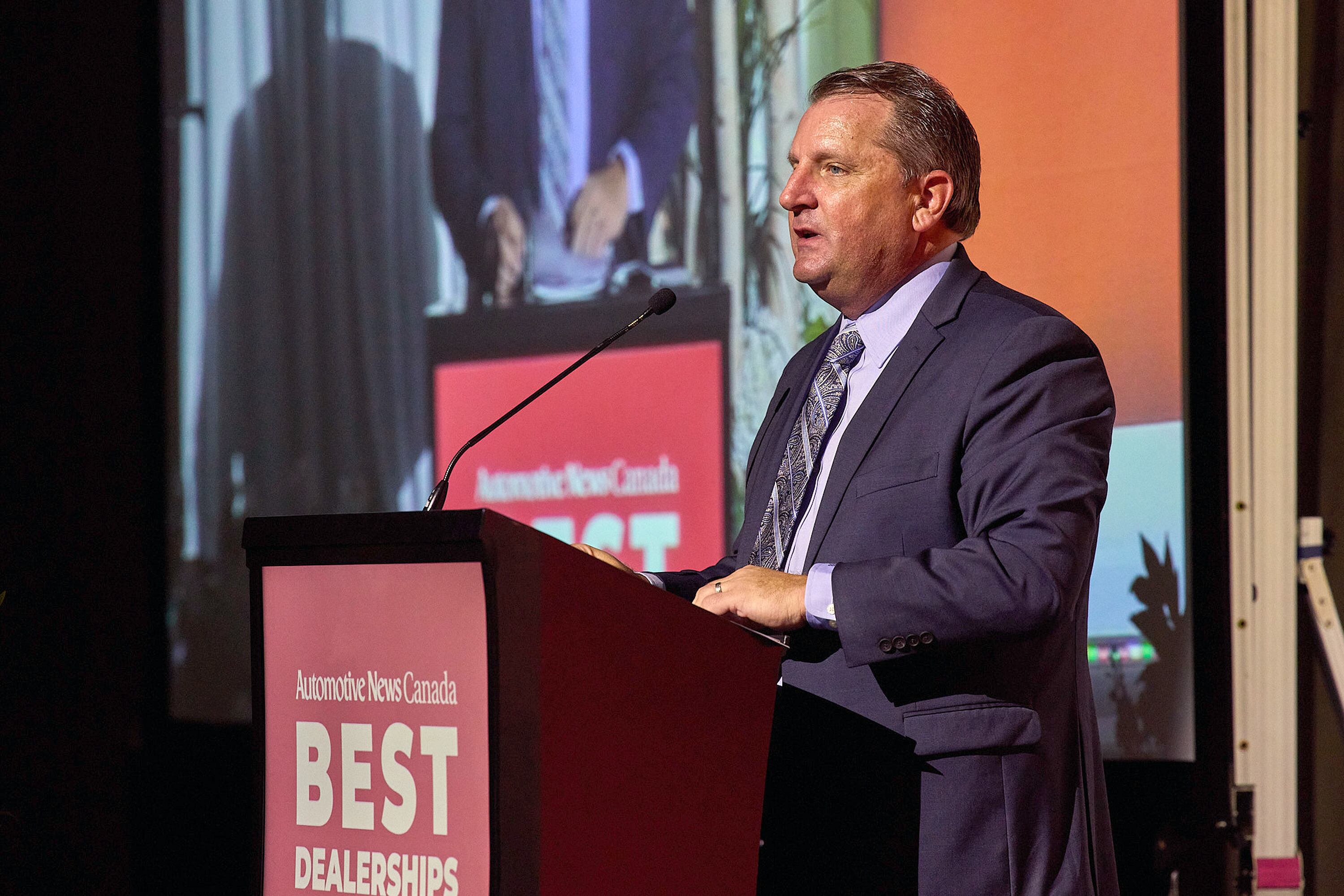 Peter Burke at the podium, on stage Oct. 24 for the Automotive News Canada Best Dealerships To Work For Program